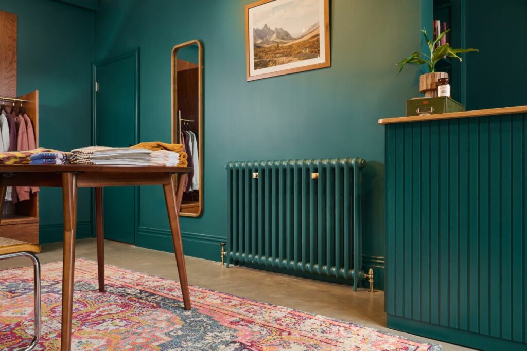 Cast iron radiator in menswear store, Chorlton, UK